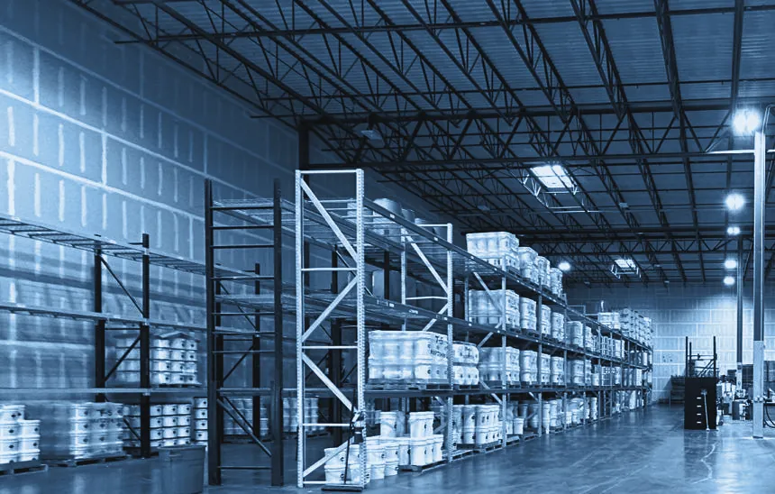 A clear warehouse floor with racking along the walls