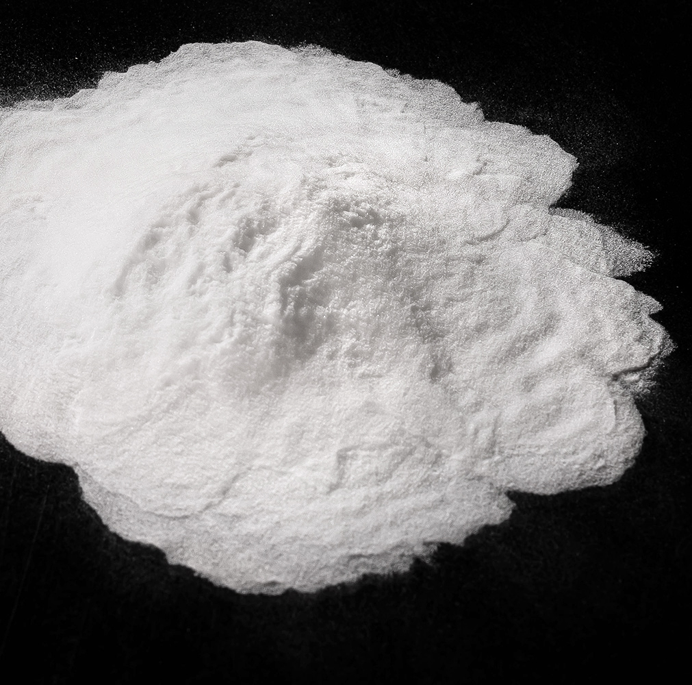 Close up overhead shot of a mound of white powder in a on a black background.