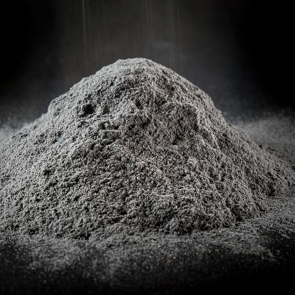 Gray powder in a pile on a black background.