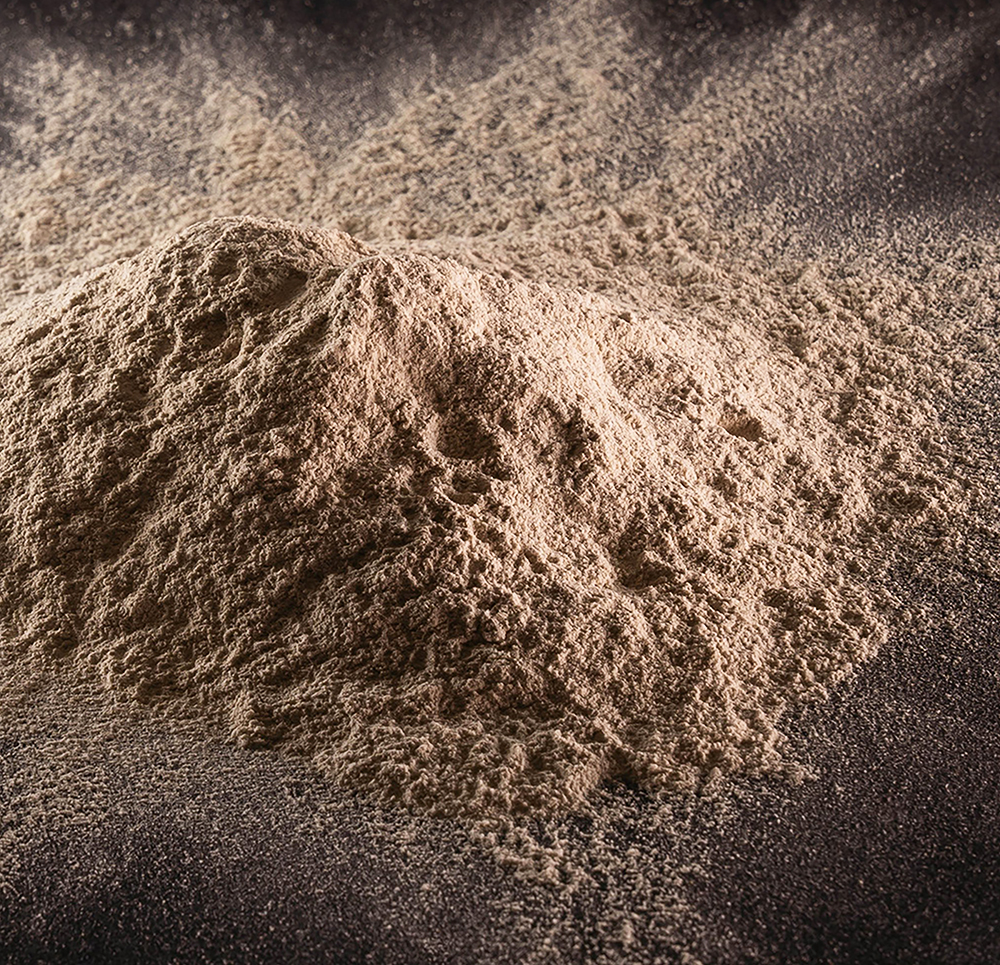 Tan powder in a messy pile with powder spread around.